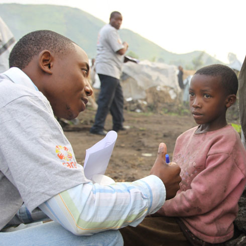 Un employé CARE parle avec un petit garçon.